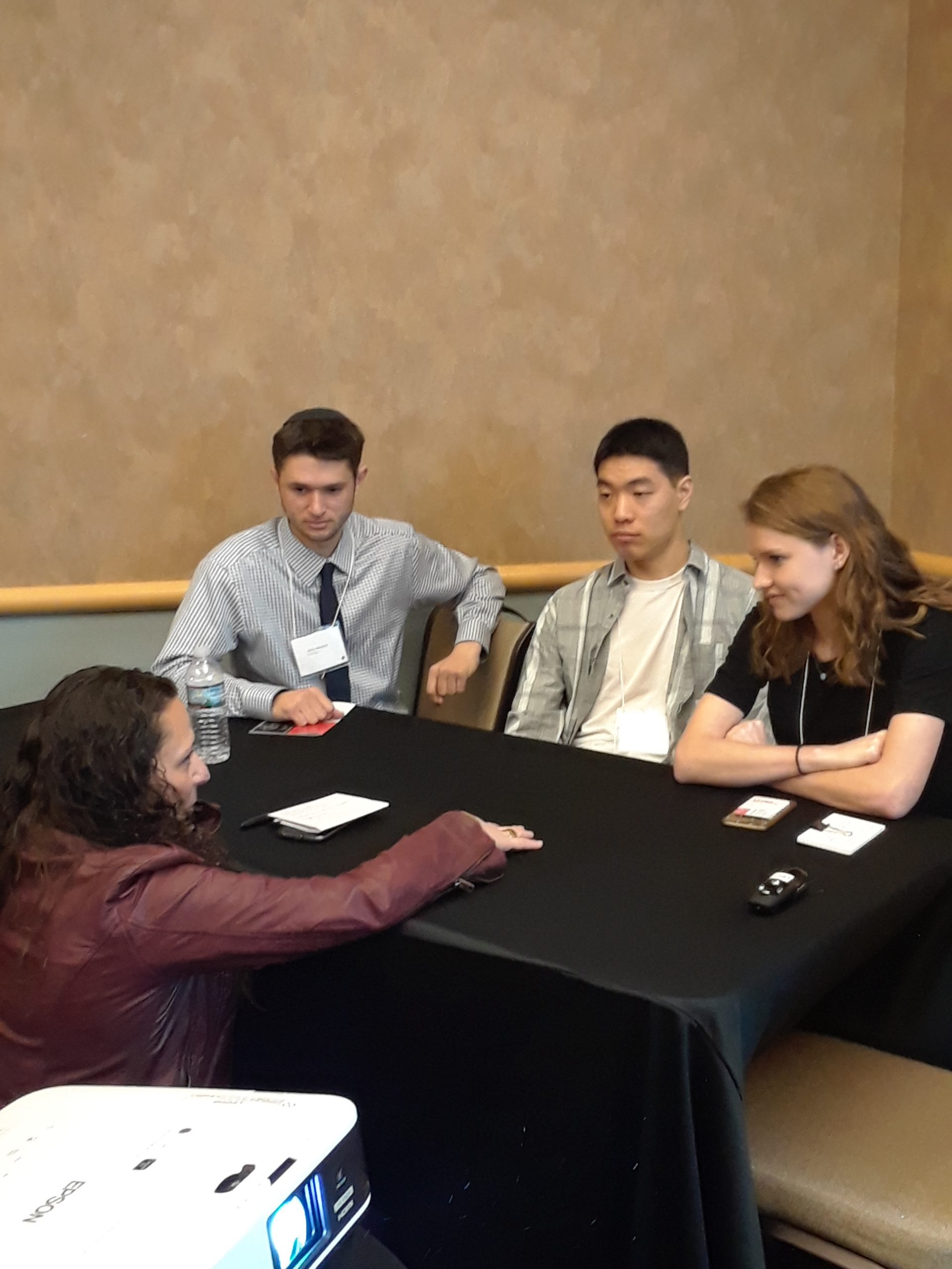 Students discussing around a table